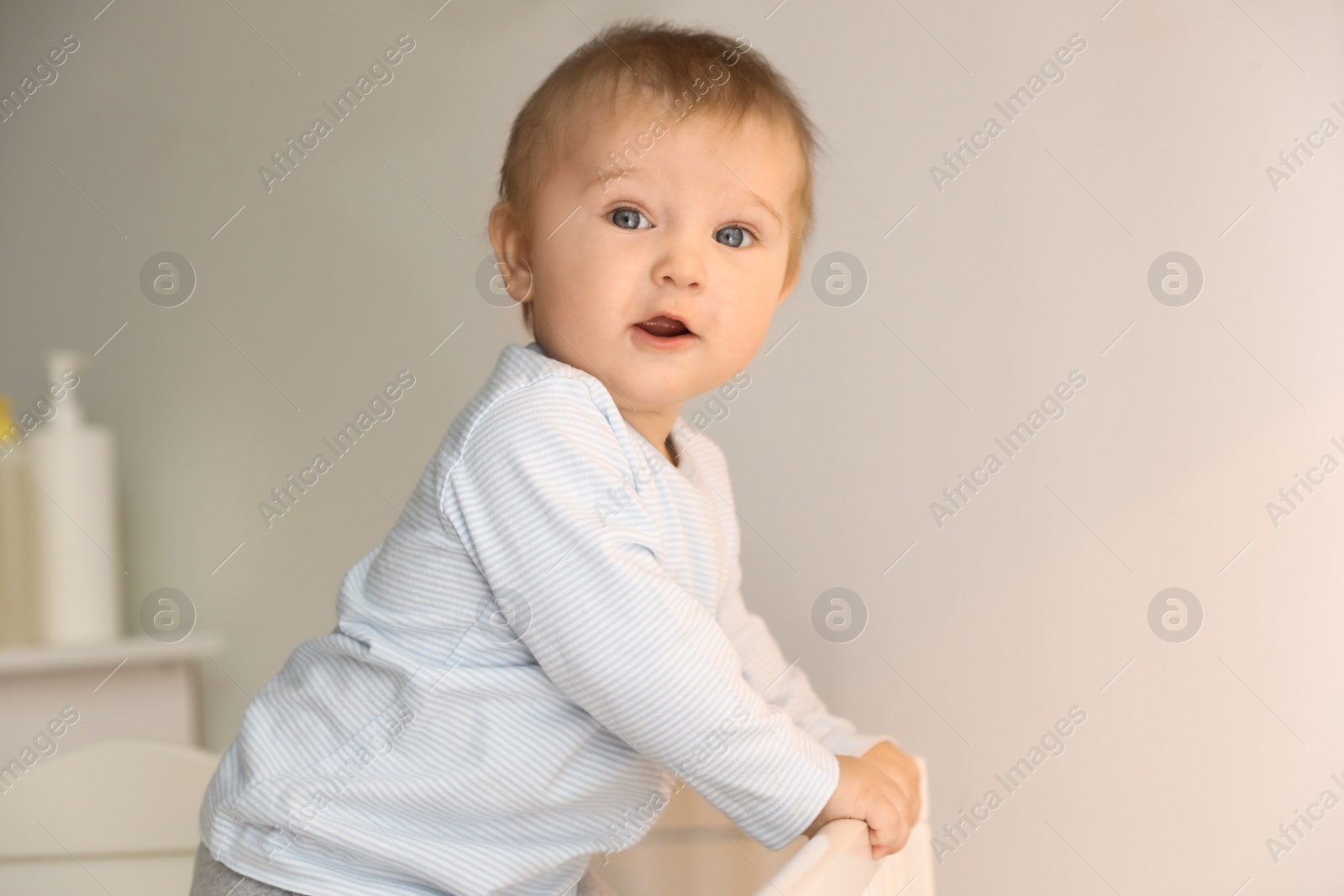 Photo of Cute little baby in crib at home