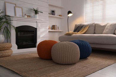 Stylish comfortable poufs near sofa in room. Home design