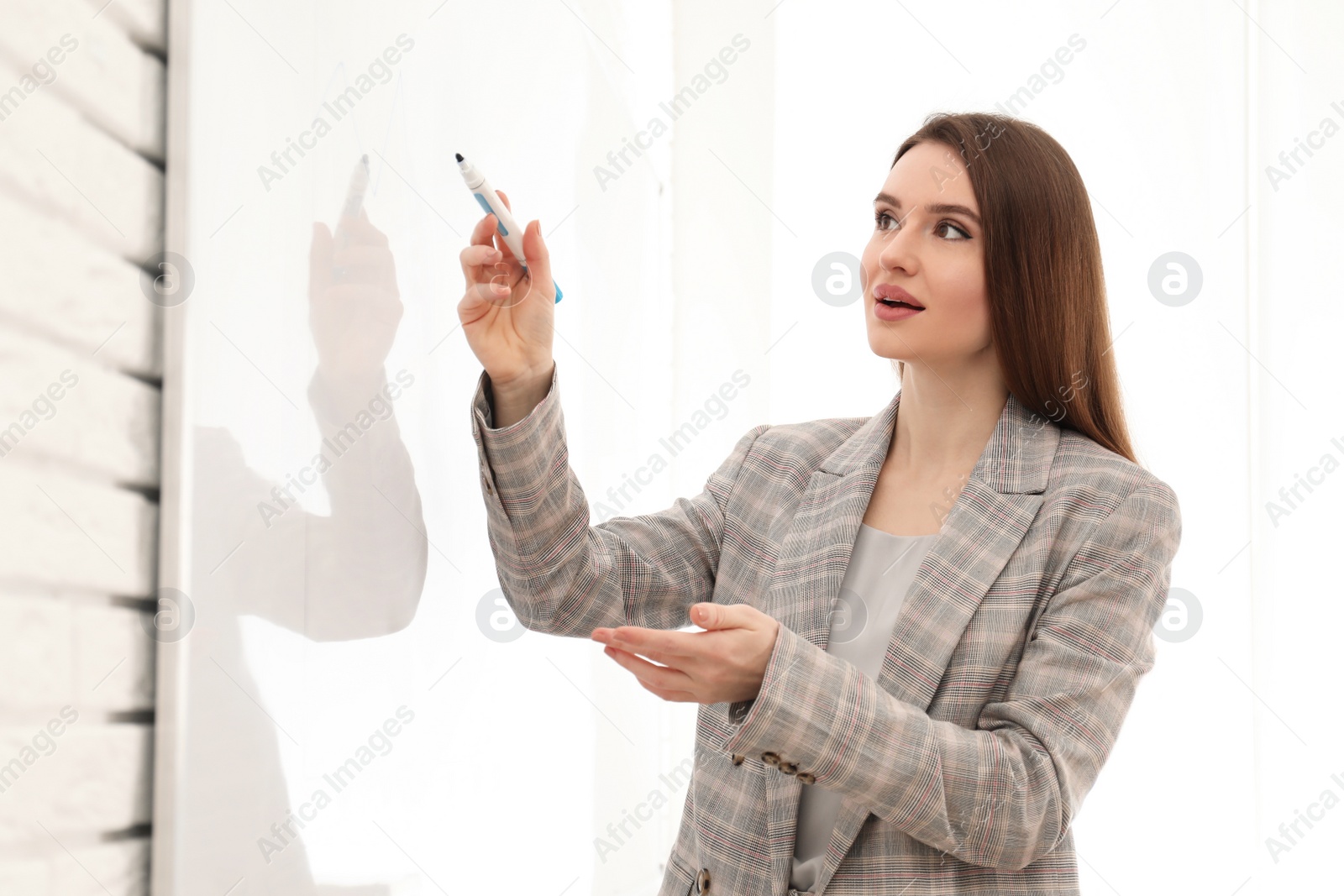 Photo of Professional business trainer near whiteboard in office