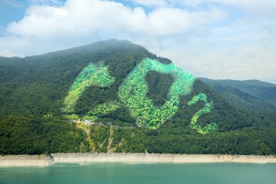 Image of Concept of clear air. CO2 inscription, beautiful mountain landscape and lake