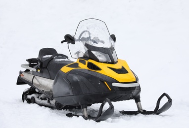 Photo of New stylish snowmobile parked outdoors. Winter recreation