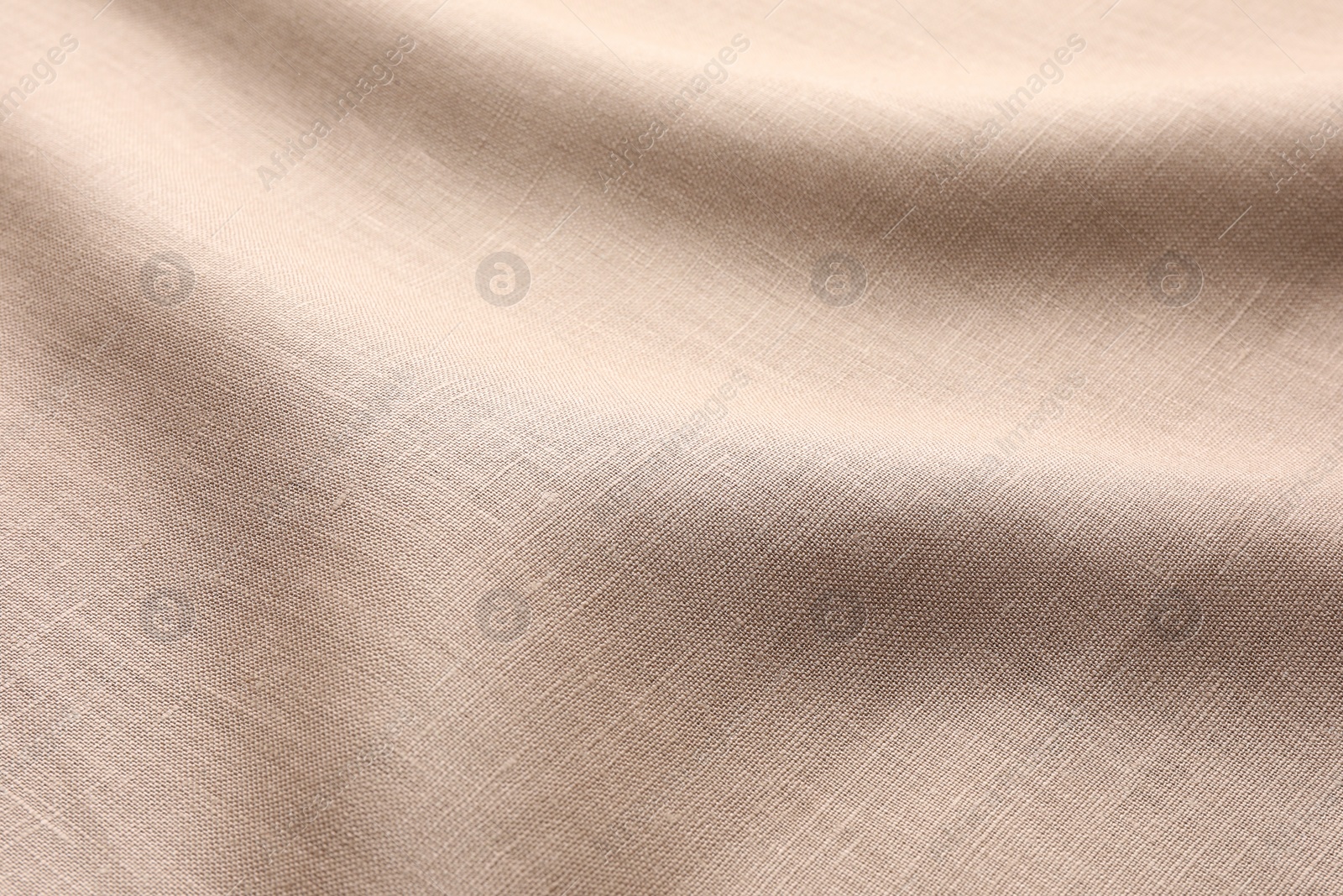 Photo of Texture of beige crumpled fabric as background, closeup
