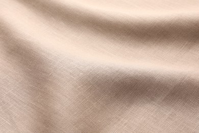 Texture of beige crumpled fabric as background, closeup