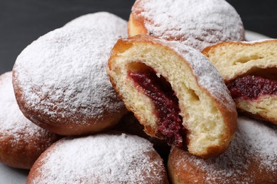 Delicious sweet buns with jam and powdered sugar, closeup