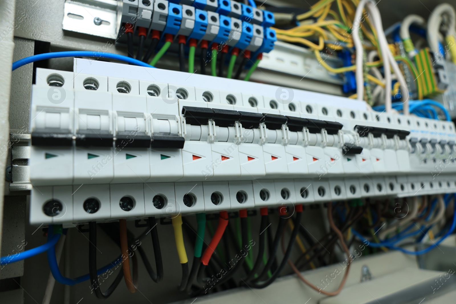 Photo of Electrical panel with many wires in fuse box, closeup