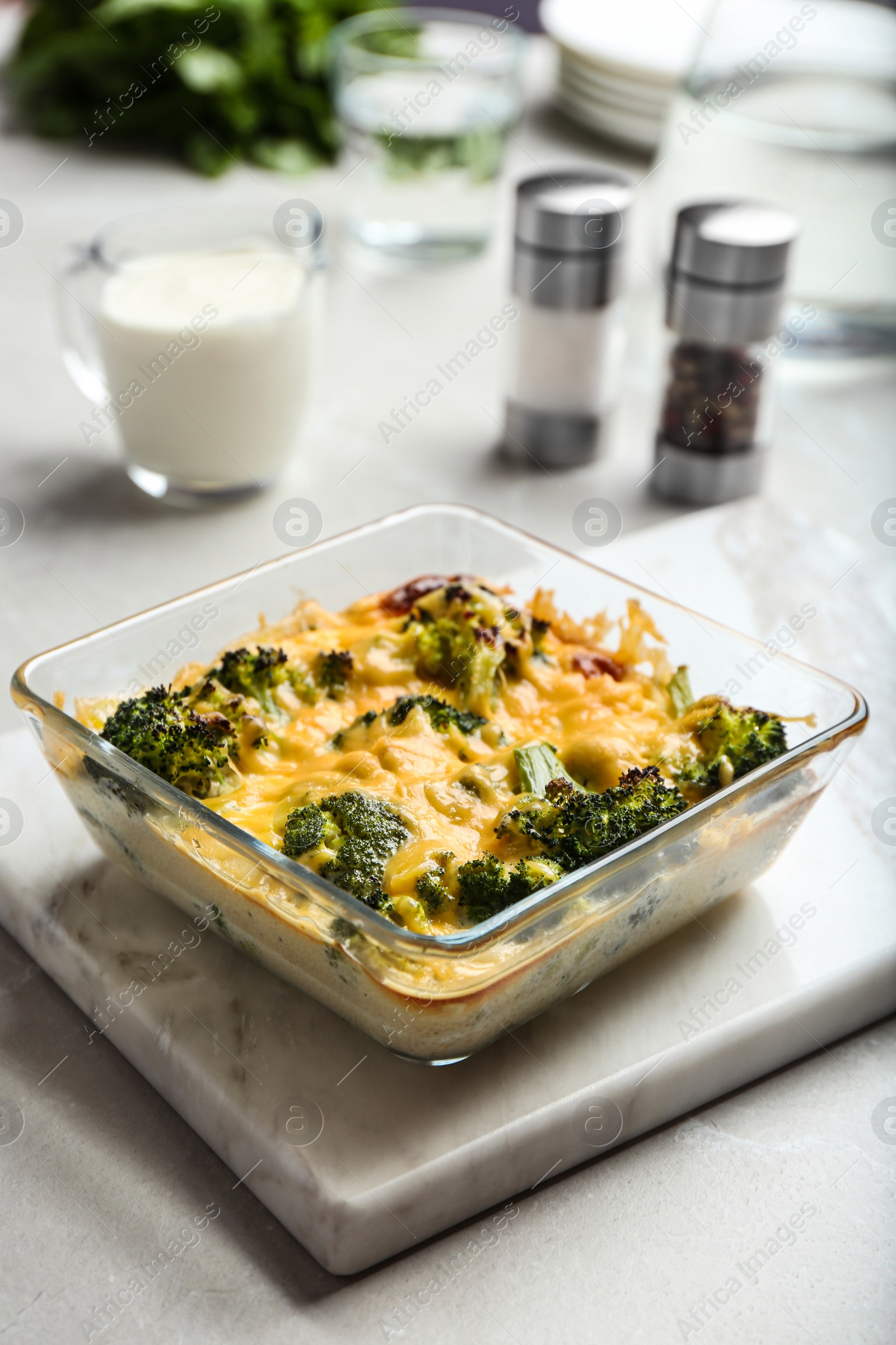 Photo of Tasty broccoli casserole in baking dish on table