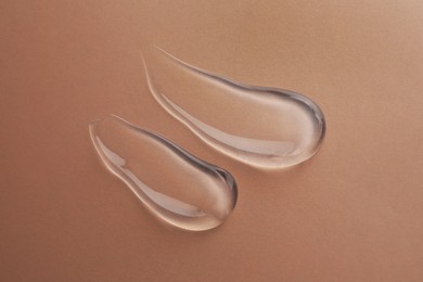 Photo of Sample of transparent gel on color background, top view