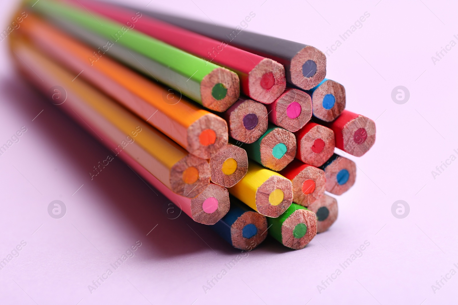 Photo of Different color pencils on light background, closeup