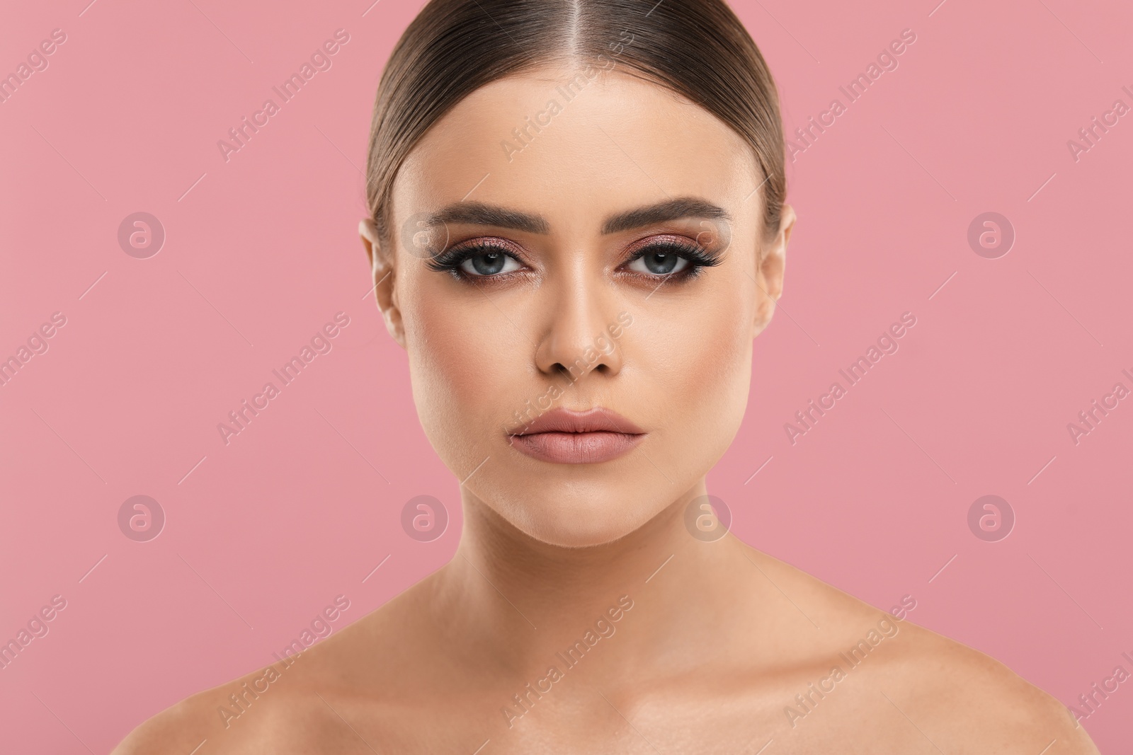 Photo of Beautiful woman with makeup on pink background