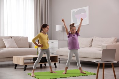 Cute little girls taking online dance class at home