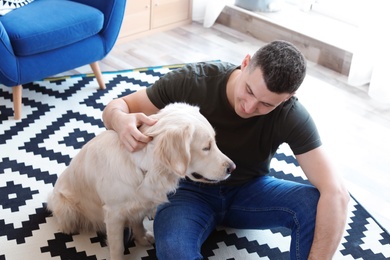 Photo of Portrait of owner with his friendly dog at home