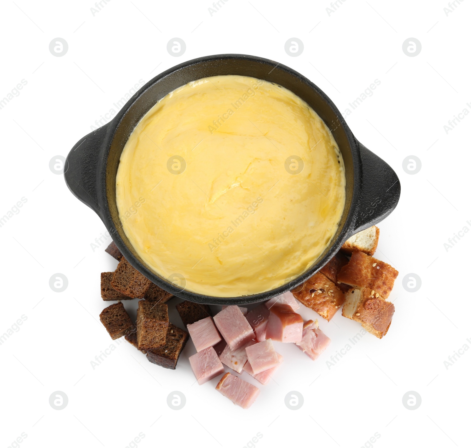 Photo of Fondue with tasty melted cheese, pieces of bread and ham isolated on white, top view