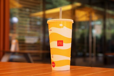 Photo of MYKOLAIV, UKRAINE - AUGUST 11, 2021: Cold McDonald's drink on table in cafe