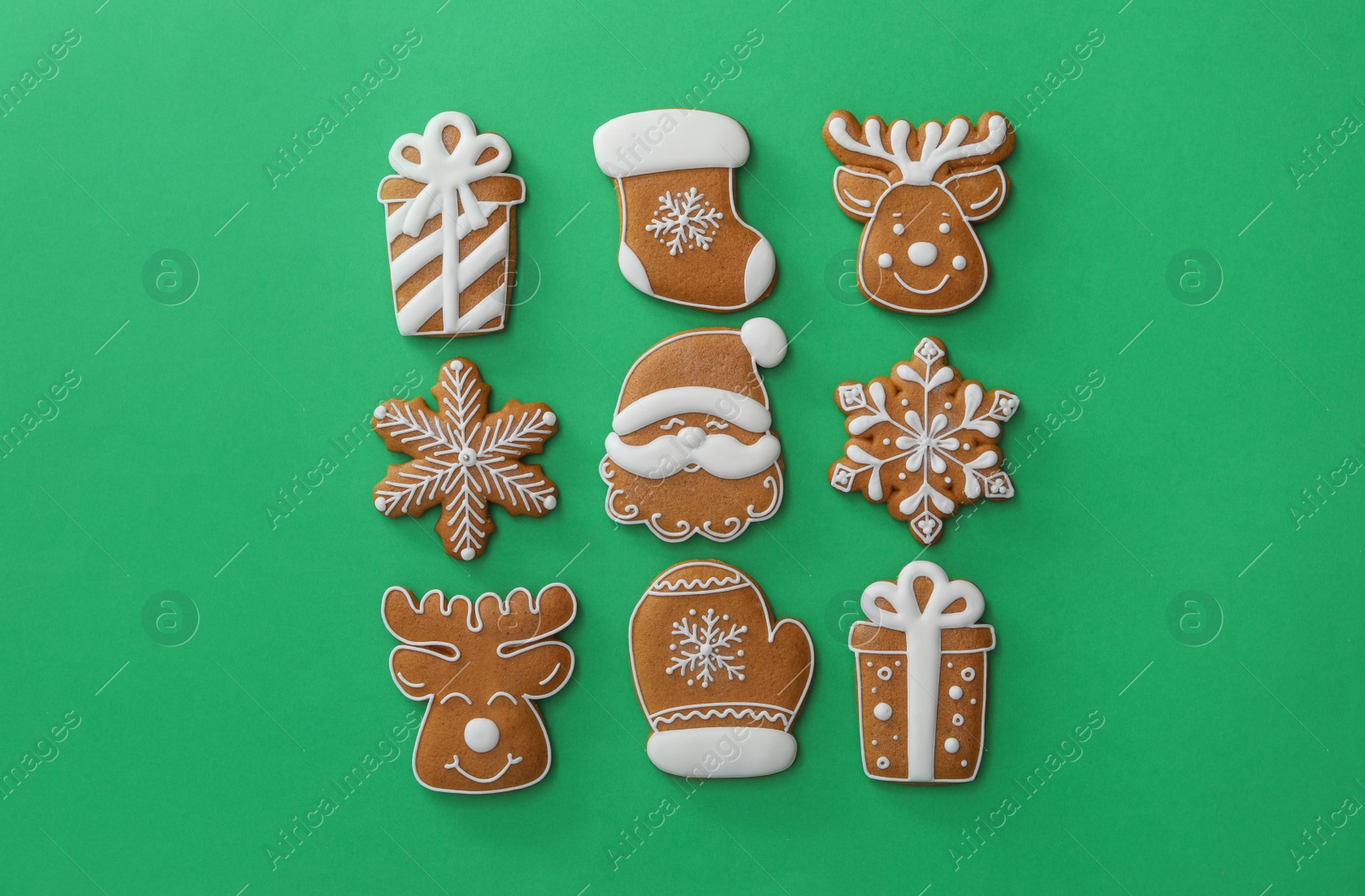 Photo of Different Christmas gingerbread cookies on green background, flat lay