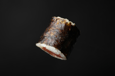 Photo of Sushi roll with tuna on black background