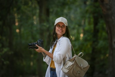 Photo of Beautiful woman with camera spending time in nature reserve