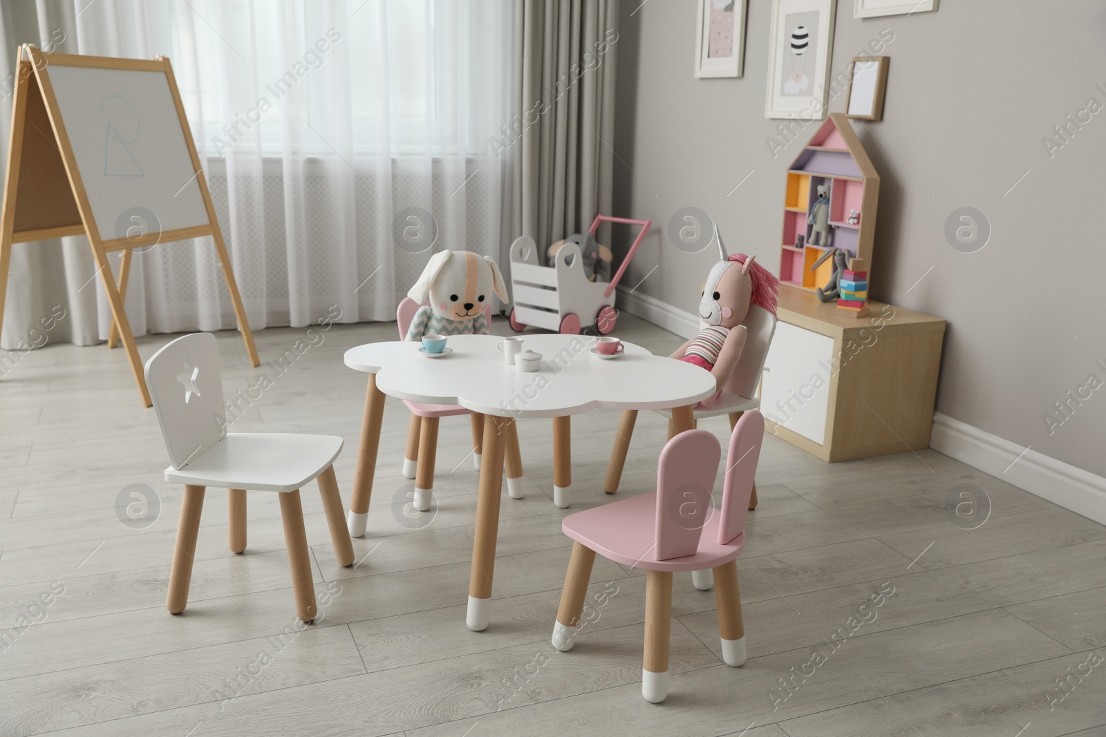 Photo of Child's room interior with stylish table, chairs and toys