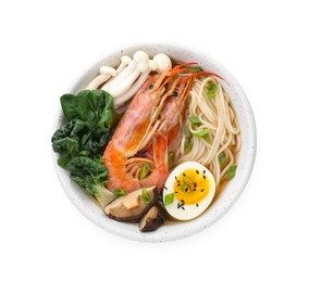 Photo of Delicious ramen with shrimps and egg in bowl isolated on white, top view. Noodle soup