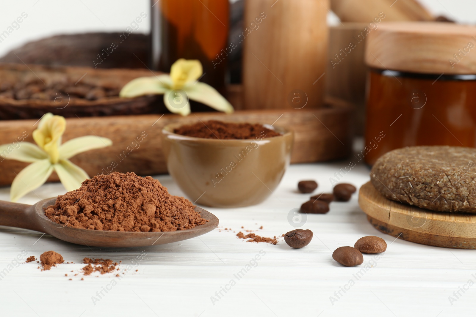 Photo of Homemade cosmetic products and fresh ingredients on white wooden table, closeup