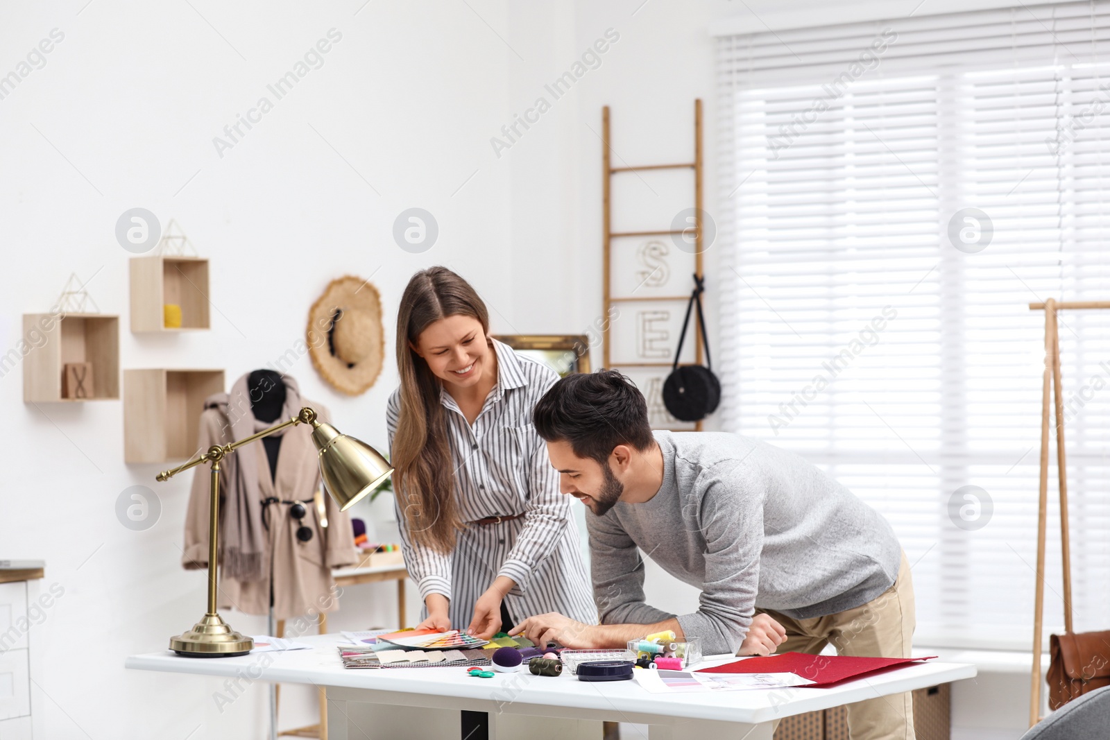 Photo of Fashion designers creating new clothes in studio