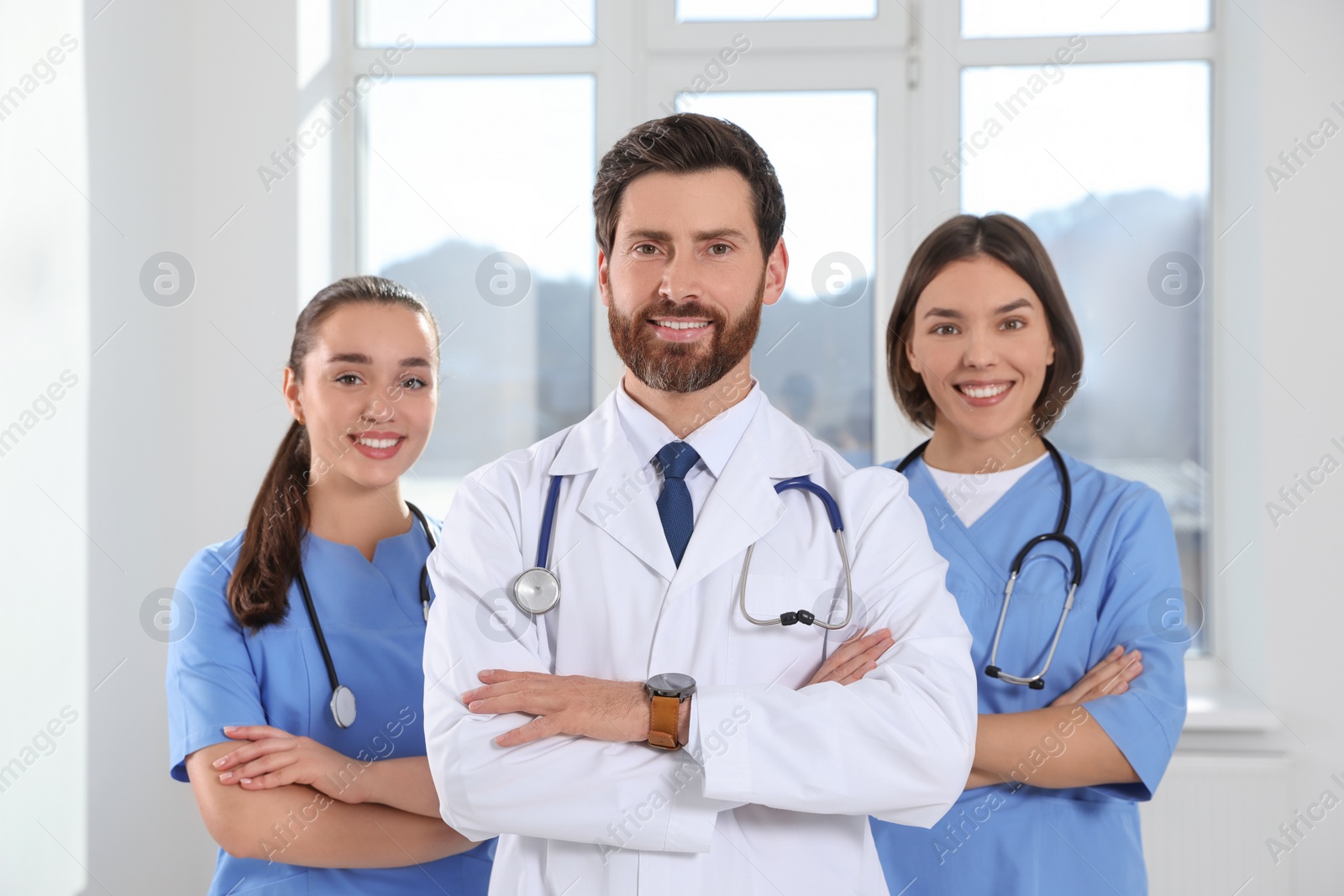 Photo of Team of professional doctors in clinic hallway