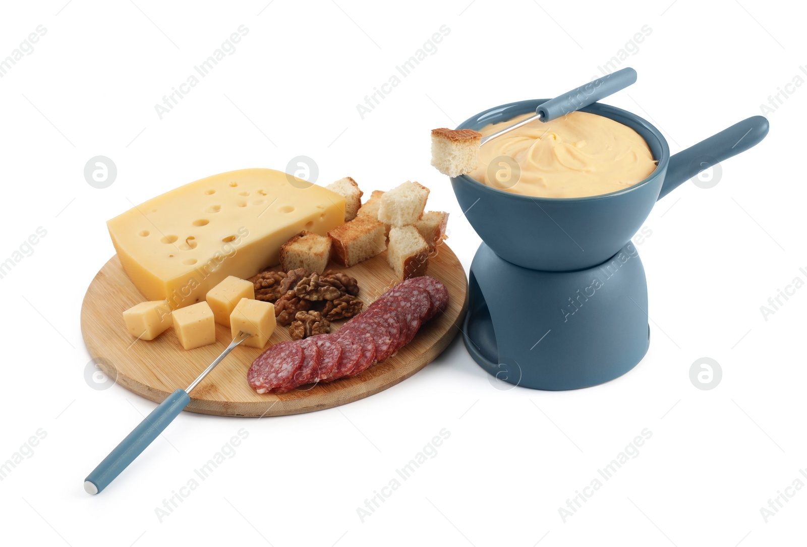 Photo of Fondue with tasty melted cheese, forks and different snacks isolated on white