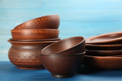Photo of Set of clay utensils on blue wooden table