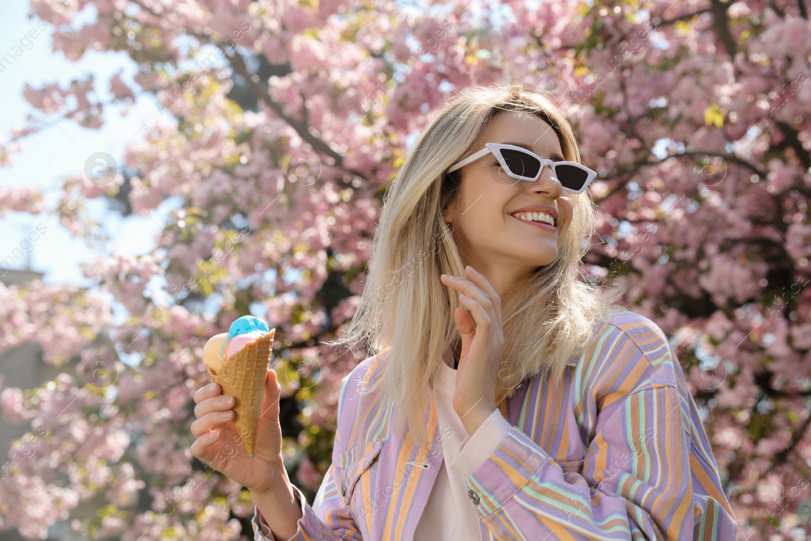 Photo of Young woman with icecream in beautiful park