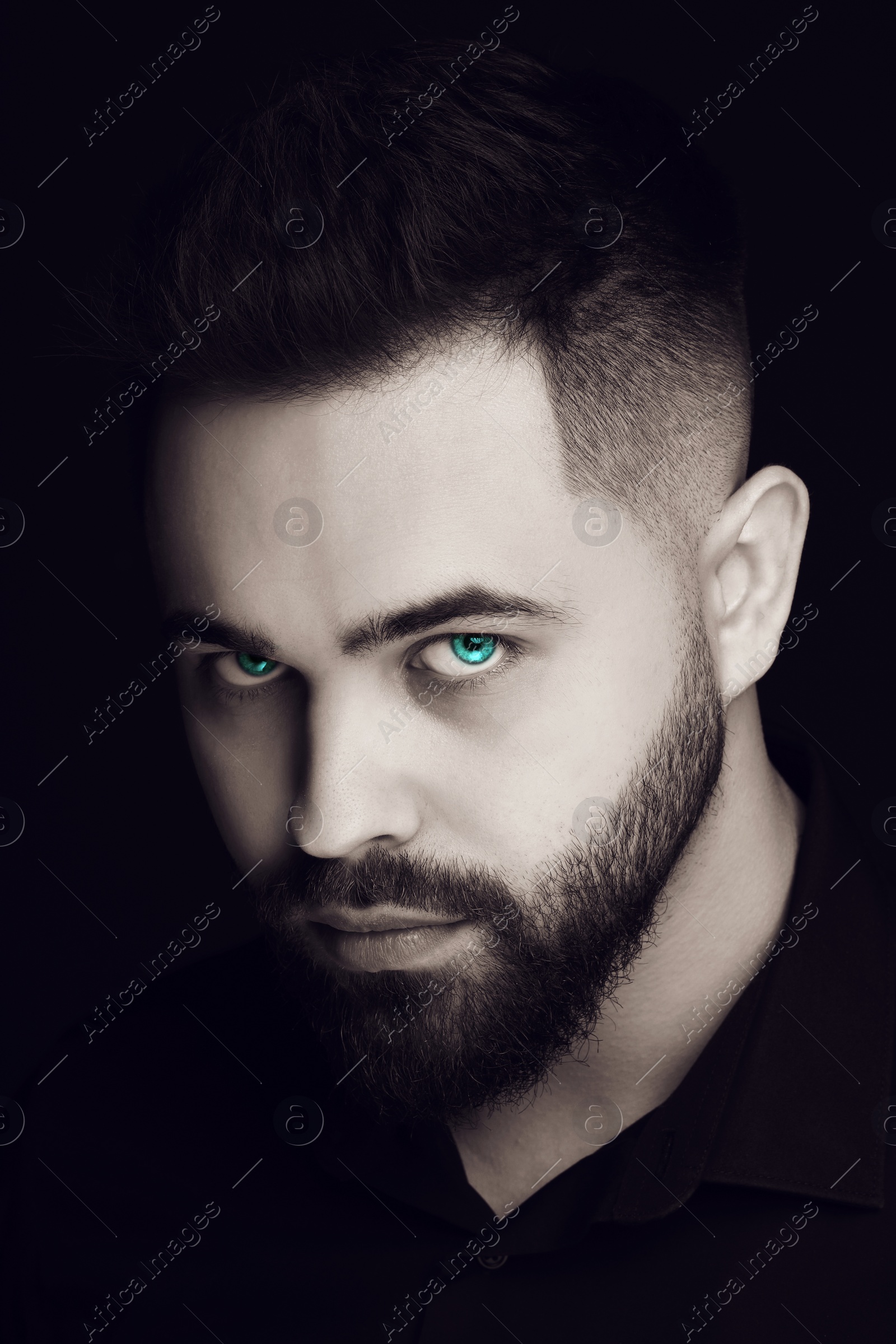 Image of Evil eye, captivating gaze. Man with cyan eyes, closeup