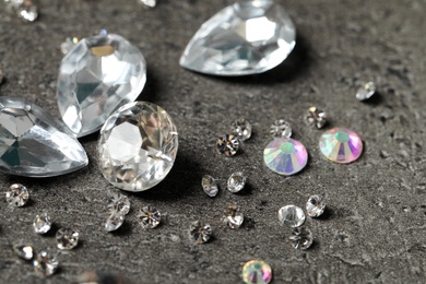 Photo of Beautiful gemstones for jewelry on grey background, closeup