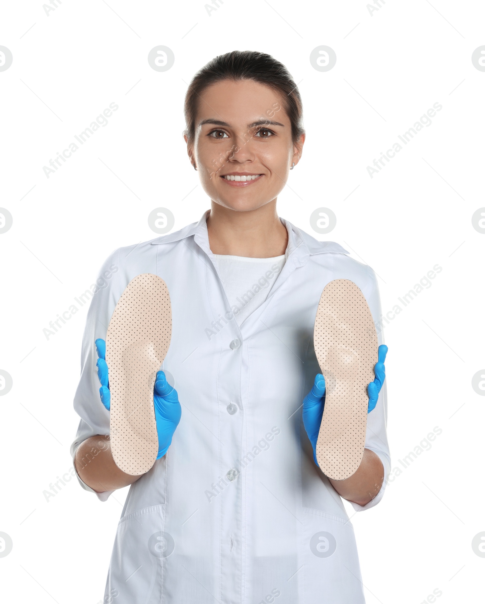 Photo of Beautiful female orthopedist showing insoles on white background