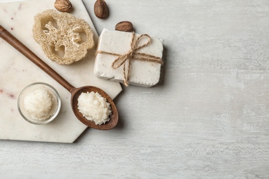 Flat lay composition with Shea butter and handmade soap on light background. Space for text