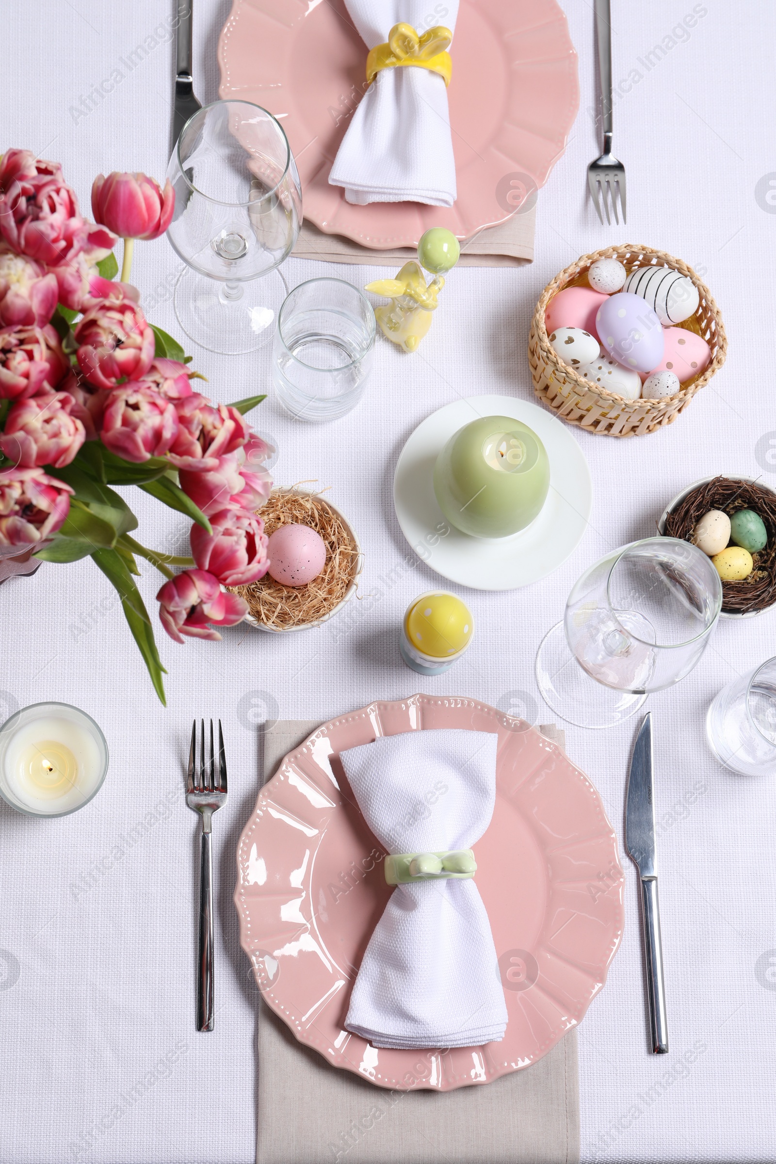 Photo of Festive table setting with beautiful flowers, flat lay. Easter celebration