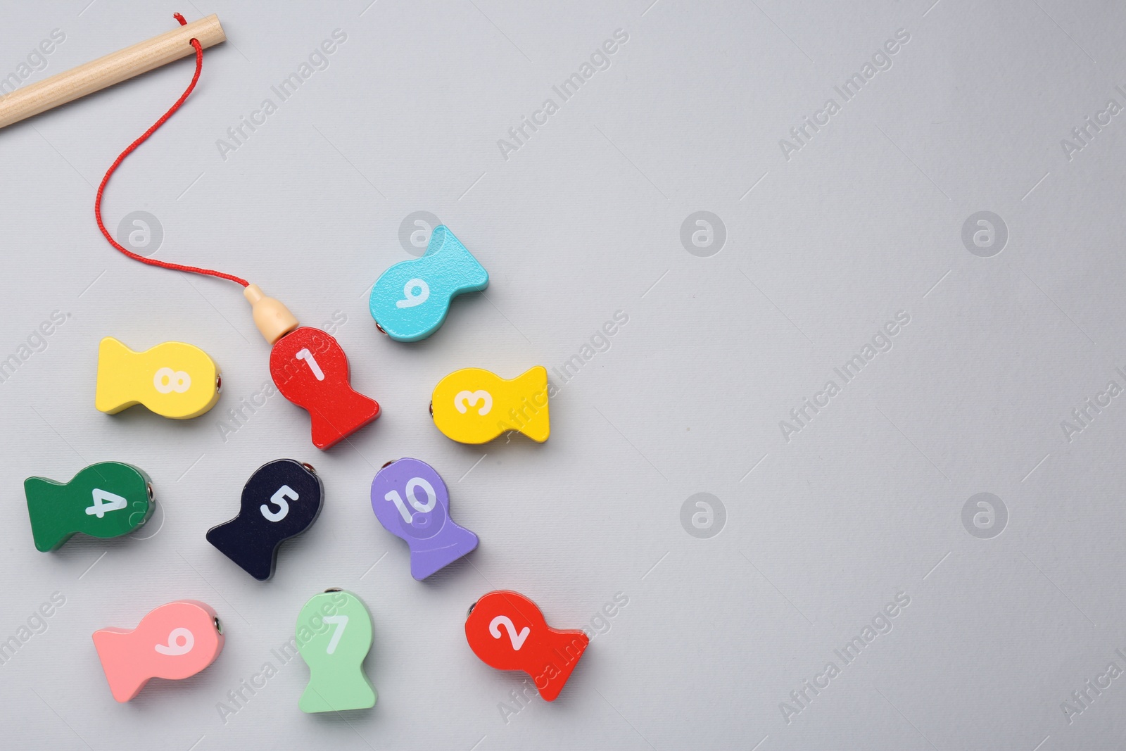 Photo of Educational game Fishing for Numbers on light grey background, flat lay. Space for text