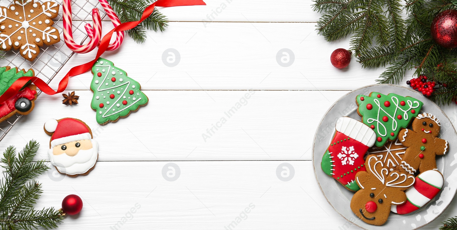 Photo of Tasty homemade Christmas cookies and decor on white wooden table, flat lay. Space for text