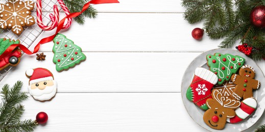 Photo of Tasty homemade Christmas cookies and decor on white wooden table, flat lay. Space for text