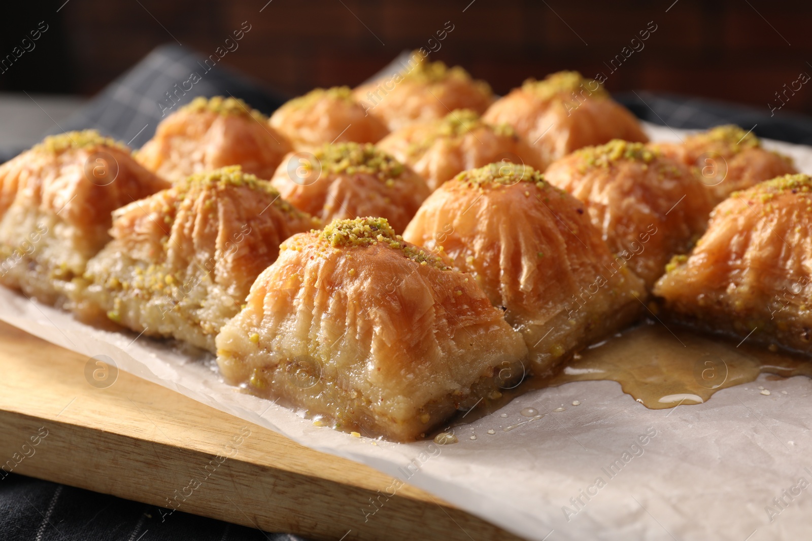 Photo of Delicious sweet baklava with pistachios on table, closeup