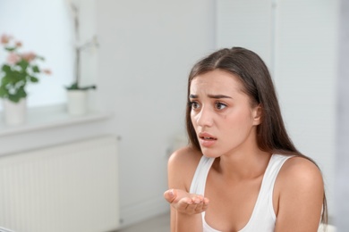 Photo of Young woman with eyelash loss problem indoors