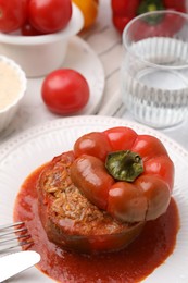 Photo of Delicious stuffed bell pepper served on light table