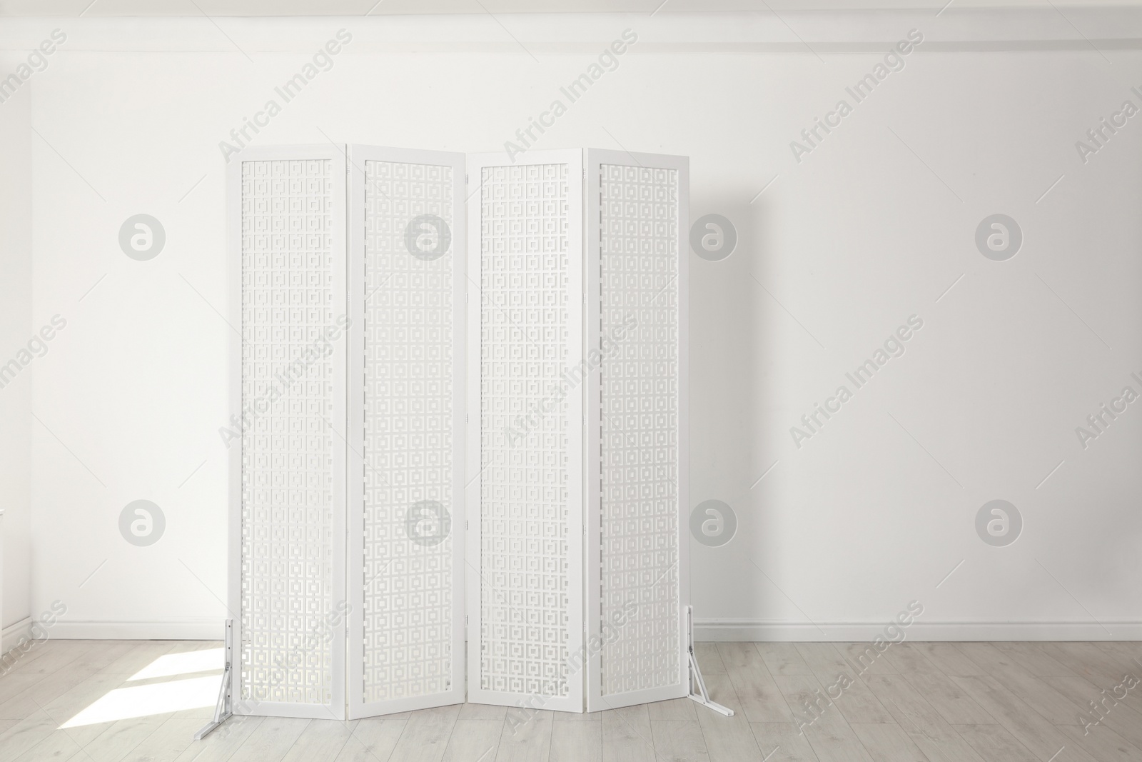 Photo of Modern folding screen in light spacious room