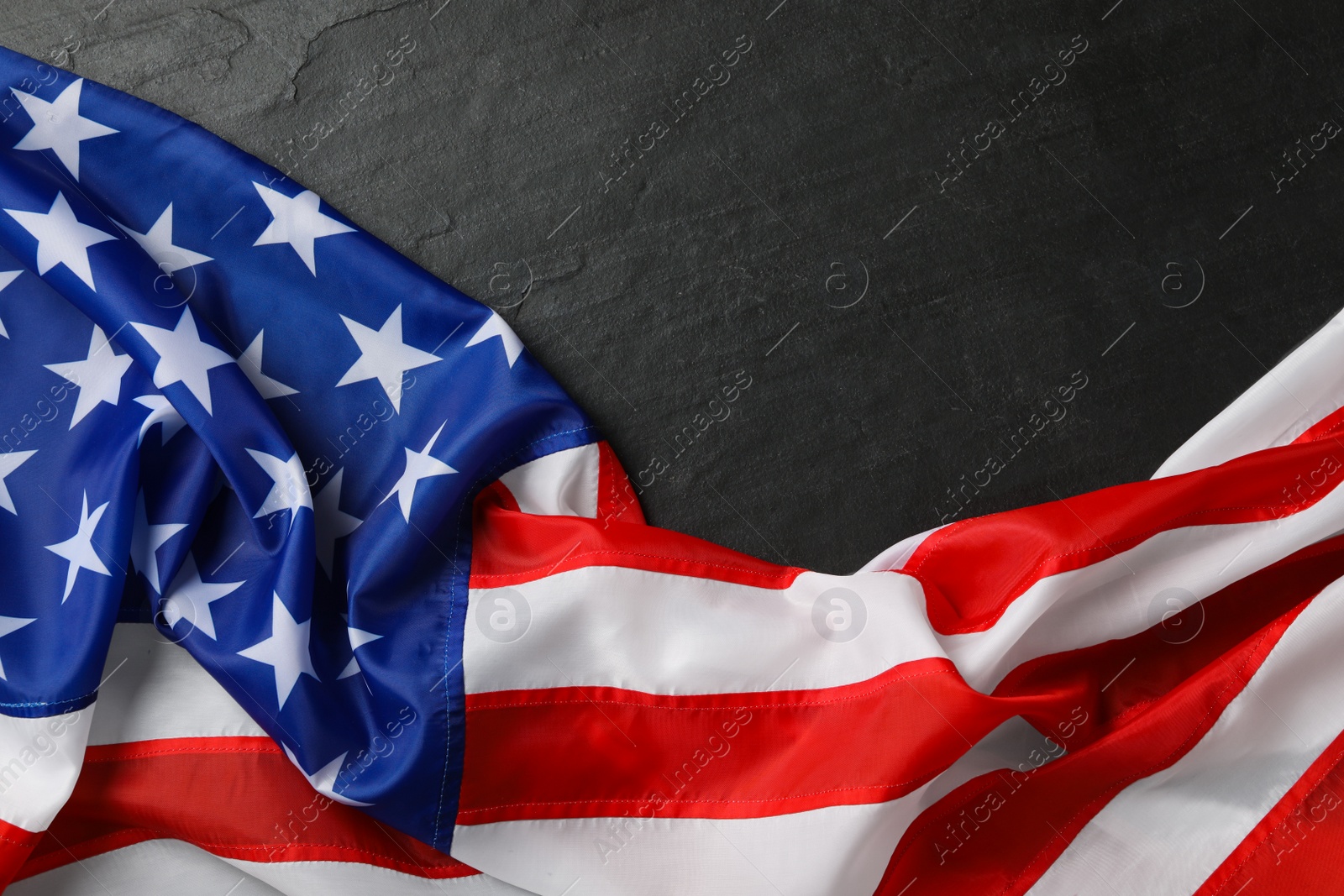 Photo of American flag on black table, top view with space for text. Memorial Day