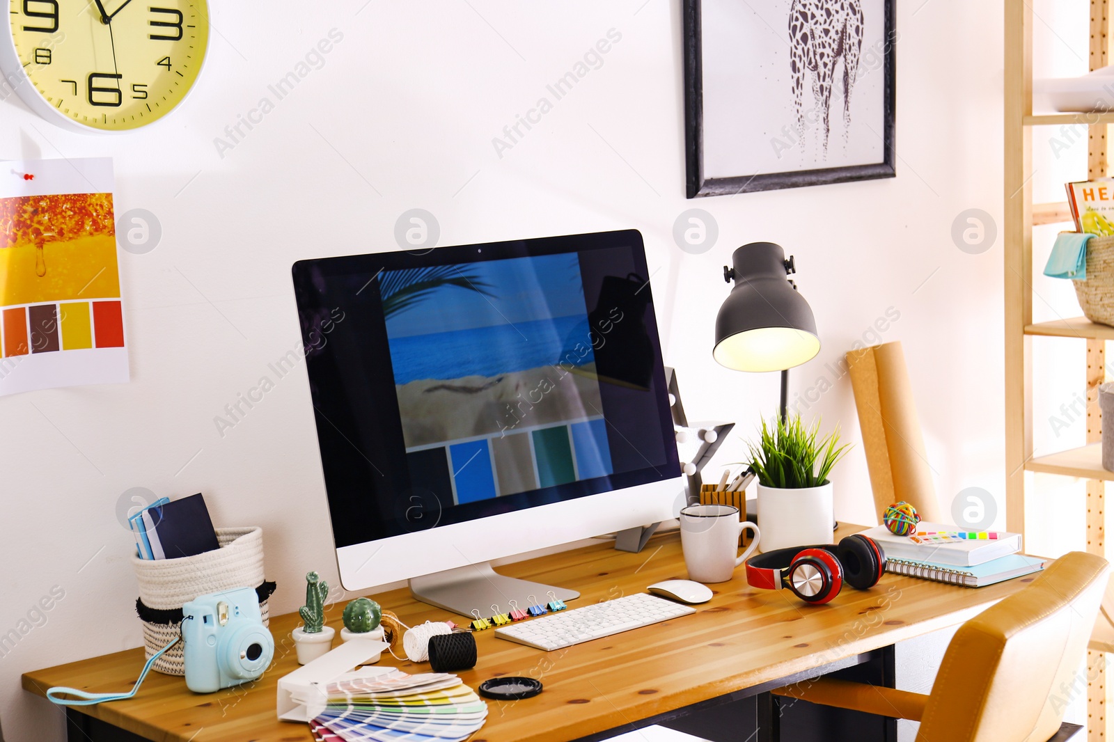 Photo of Comfortable designer's workplace with modern computer in studio