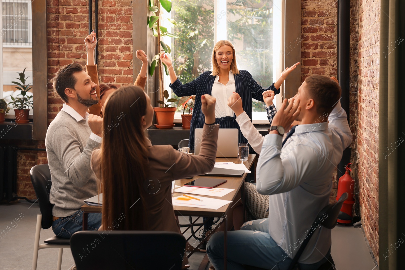 Photo of Businesswoman having meeting with her employees in office. Lady boss