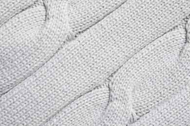 Texture of soft light knitted fabric as background, top view