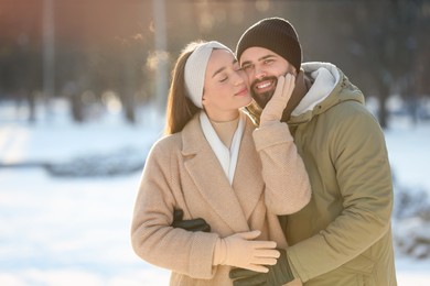 Beautiful young couple enjoying winter day outdoors