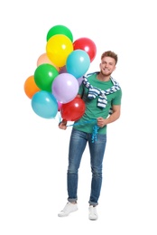 Photo of Young man holding bunch of colorful balloons on white background