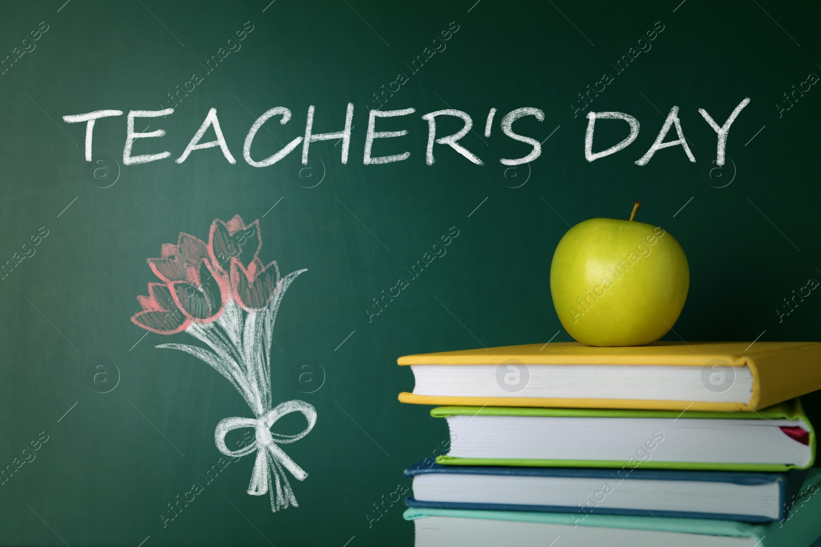 Image of Text Teacher's Day and bouquet drawing on green chalkboard near stacked books with apple. Greeting card design