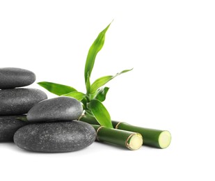Photo of Spa stones and bamboo stems on white background