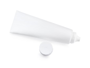 Photo of Blank tube of toothpaste isolated on white, top view