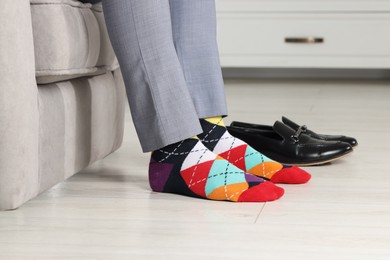 Man wearing colorful socks indoors, closeup view